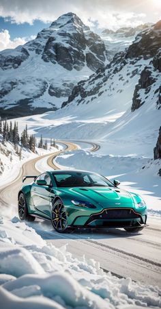 a green sports car driving on a snowy road in the mountains near snow covered trees