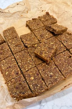 several pieces of brownie sitting on top of parchment paper