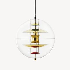 a glass ball hanging from the ceiling with three different colored objects in it's center