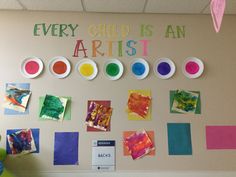 the wall is decorated with colorful paper plates and art supplies for children's artwork