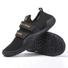 a pair of black shoes with yellow lettering on the side and one shoe has two straps