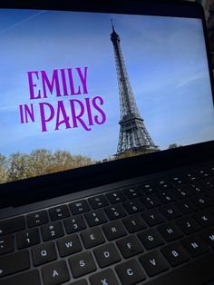 an open laptop computer with the eiffel tower in paris on it's screen