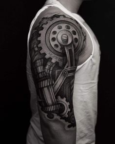 a black and white photo of a man's arm with gears on it