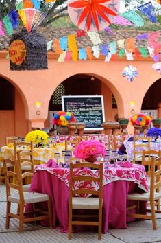 tables and chairs are set up with colorful decorations