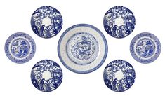 six blue and white plates sitting next to each other