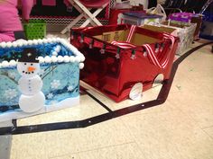 a snowman in a house made out of plastic bags and other items on the floor