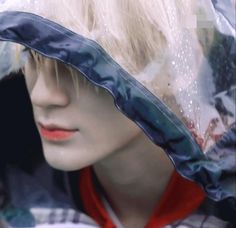 a mannequin's head wearing a plastic hat with raincoat on it