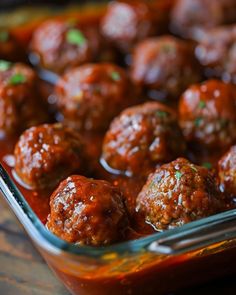 some meatballs are sitting in a glass dish