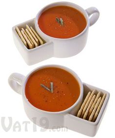 two white cups filled with soup and wooden skewers sitting on top of each other