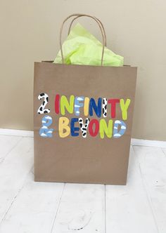 a brown paper bag with the word infinity and beyond painted on it sitting on a white floor