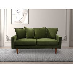 a green couch sitting on top of a rug