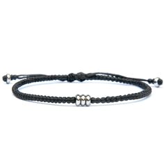 Introducing the "Iron Flow" bracelet – a symbol of strength and protection. Handcrafted in the UK, this sleek black cord bracelet adorned with steel beads is the perfect iron 6th anniversary gift, embodying durability and resilience.  Steel, renowned for its protective properties, makes this bracelet more than just an accessory; it's a shield against the trials of life, offering both physical and emotional fortitude.  Discover the elegance of iron jewellery with the "Iron Flow" bracelet, a minim Everyday Metal Bracelets With Sliding Knot, Modern Metal Jewelry With Black Band, Modern Adjustable Jewelry With Black Band, Black Leather And Stainless Steel Adjustable Bracelet, Metal Bracelets With Sliding Knot, Metal Bracelet With Black Band As Gift, Metal Jewelry With Black Band For Gift, Minimalist Metal Leather Bracelet For Everyday Wear, Modern Black Jewelry With Sliding Knot