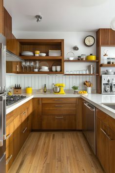 the kitchen is clean and ready for us to use it's wood flooring