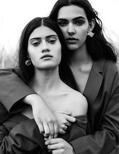 two women in black and white posing for the camera