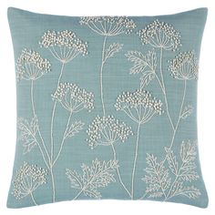 a blue pillow with white flowers on it