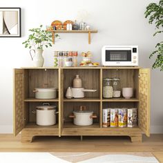 a microwave oven sitting on top of a wooden shelf filled with pots and pans