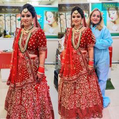 two women in red outfits posing for the camera