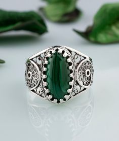 "Malachite Gemstone 925 Sterling Silver Artisan Made Handcrafted Filigree Art Cocktail Ring Ring Face Length is 0.65\" and Width is 0.30\" Natural Malachite Gemstone is 7X14 mm oval cabochon cut. This metal embroidery filigree ring is oxidized and highly polished. Comes with velvet pouch and luxurious gift box. Filigree is made of delicate metal strands that have been skillfully fashioned to create an outstanding combination of old and modern art. Originating in Mesopotamia, Anatolia. It is made Sterling Silver Spiritual Filigree Ring, Spiritual Sterling Silver Round Filigree Ring, Green Oval Filigree Ring In Sterling Silver, Spiritual Sterling Silver Filigree Ring, Green Sterling Silver Filigree Ring, Ornate Sterling Silver Filigree Ring With Stone Setting, Green Rings With Intricate Design For Gift, Ornate Green Filigree Ring As A Gift, Spiritual Filigree Ring Jewelry