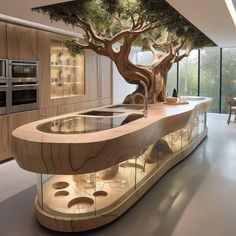 a kitchen with a tree on the wall and an island in the middle that is built into the floor