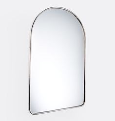 a mirror that is on the wall in front of a white background with no people around it