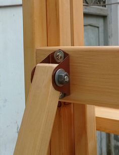 a close up of a wooden frame with metal latches on the outside of it