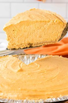 a piece of pumpkin pie being lifted out of the oven by a spatula on top of it