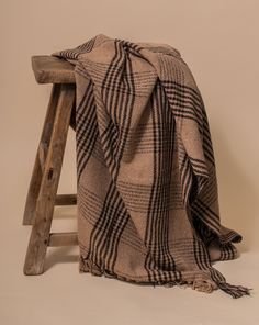 a blanket sitting on top of a wooden stool