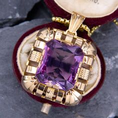 This fabulous large amethyst pendant is centered with a rectangular cut amethyst that is accented with a halo of high polished open gold work. The pendant is crafted in 14k yellow gold and is about 1.25" long. We have added an 18 inch long 14k yellow gold rounded box chain weighing approximately 3 grams. Luxury Purple Jewelry For Collectors, Art Deco Jewelry With Rectangular Pendant As Gift, Art Deco Jewelry With Rectangular Pendant For Gift, Purple Rectangular Jewelry For Formal Occasions, Luxury Rectangular Amethyst Jewelry, Formal Rectangular Purple Jewelry, Formal Purple Rectangular Jewelry, Luxury Purple Rectangular Jewelry, Classic Purple Jewelry With Rectangular Stone