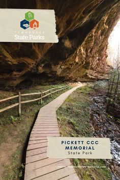 a wooden walkway leading to a cave with the words pickett cc memorial state park