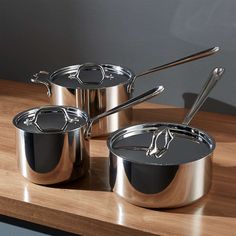 pots and pans sitting on top of a wooden counter