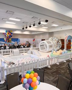 an indoor play area is decorated with balloons