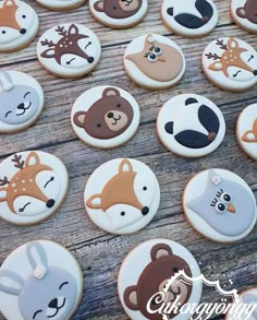 many decorated cookies with animals on them are sitting on a table and there is no image here to provide a caption for