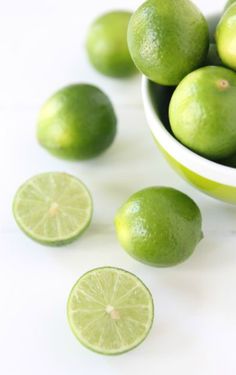 limes are in a bowl and on the table