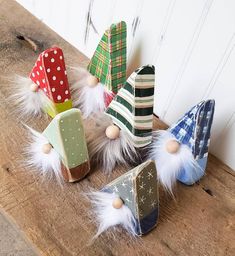 small wooden christmas trees with white feathers on them