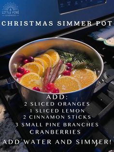 a pot filled with oranges and cranberries on top of a stove