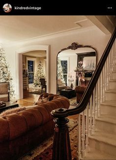 a living room filled with furniture and a christmas tree