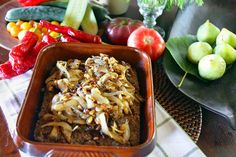 there are many different fruits and vegetables in the bowl on the table, including apples