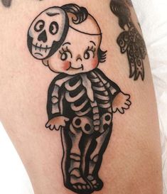 a skeleton tattoo on the leg of a man