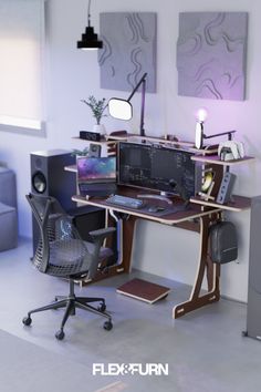 a computer desk with two monitors and speakers