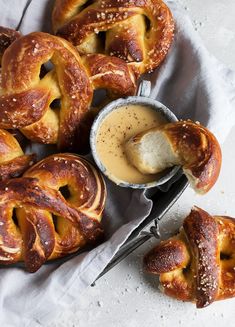 some pretzels are sitting on a table with dipping sauce