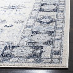 an area rug with blue and white designs on it