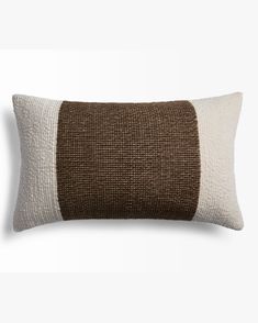 a brown and white pillow on a white background