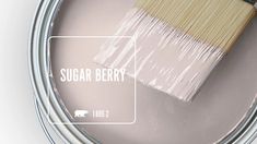 a paint can with a brush in it and the words sugar berry painted on it