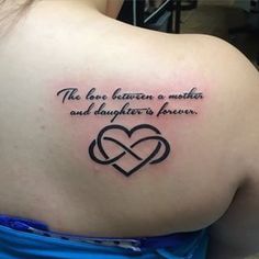 a woman with a tattoo on her back saying the love between a mother and daughter is forever