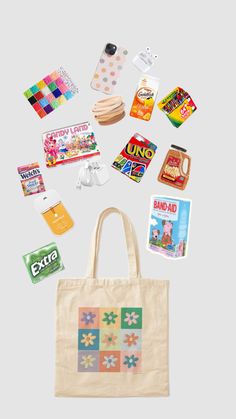 an assortment of candy, candies and other items are scattered around the tote bag