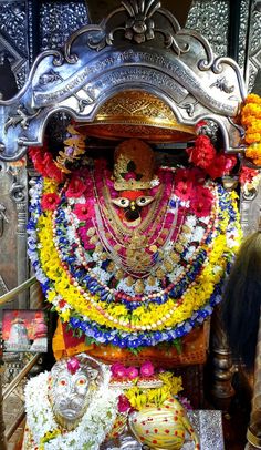 the idol is decorated with flowers and garlands