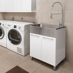 a washer and dryer sitting next to each other in a kitchen