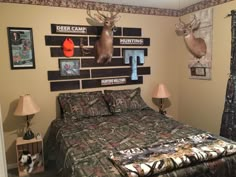 a bed room with a neatly made bed and deer head mounted to the wall above it