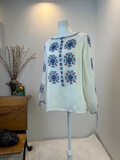 Vintage  Hungarian Blouse / Hungarian Blouse / vintage embroidered blouse / Hungarian embroidery  This is a Hungarian blouse with gorgeous embroidery down the front and along the length of each sleeve. Her neckline and cuffs are trimmed in thread for extra appeal. She is gorgeous, comfortable and light. A perfect warm weather or travel blouse.  Measurements provided are flat and have been doubled. Bust 42" Waist 42" Length 25" ❤️ Condition: Great vintage condition. Flaw: I found two tiny spot on the front hem. I am going to try and treat them and update this listing. For now, Please see photos of these tiny flaws. This item has been cleaned and is ready to wear. $148 includes domestic shipping and insurance. International shipping is $30. Please let me know if you have questions, would lik Folk Style Long Sleeve Top With Resham Embroidery, Peasant Blouse With Chikankari Embroidery, Folk Style Long Sleeve Peasant Top With Intricate Embroidery, Folk Style Peasant Top With Intricate Embroidery, Traditional Spring Peasant Top With Geometric Embroidery, Long Sleeve Peasant Top With Intricate Embroidery, Peasant Blouse With Geometric Multicolor Embroidery, Bohemian Peasant Top With Chikankari Embroidery, Bohemian Long Sleeve Peasant Top With Chikankari Embroidery