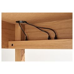 a close up of a wooden shelf with wires attached to the top and below it